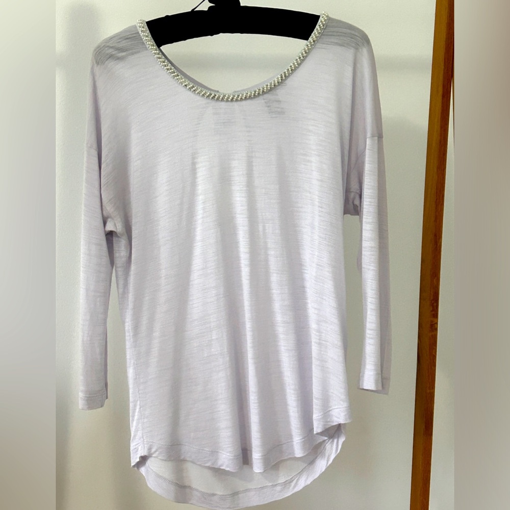 Sheer light grey top with pearl neckline.